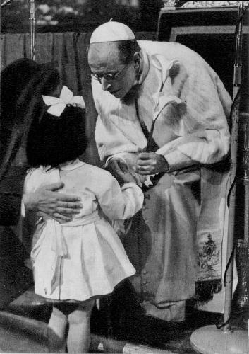 Pope Pius XII greets a little girl.